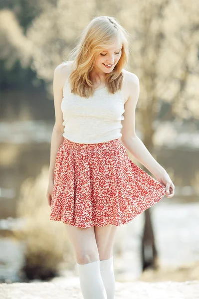 Beautiful smiling girl touching her dress — Stock Photo, Image