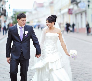 Bride and groom walking together in an old town