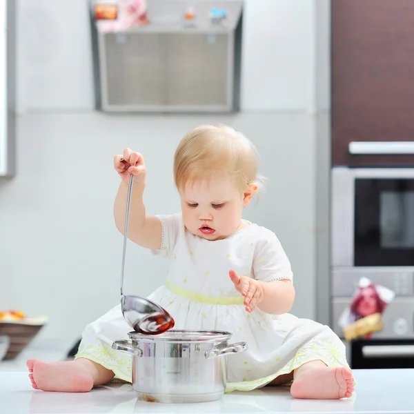 Sweet little girl cooking on a kitchen — Stock Photo, Image