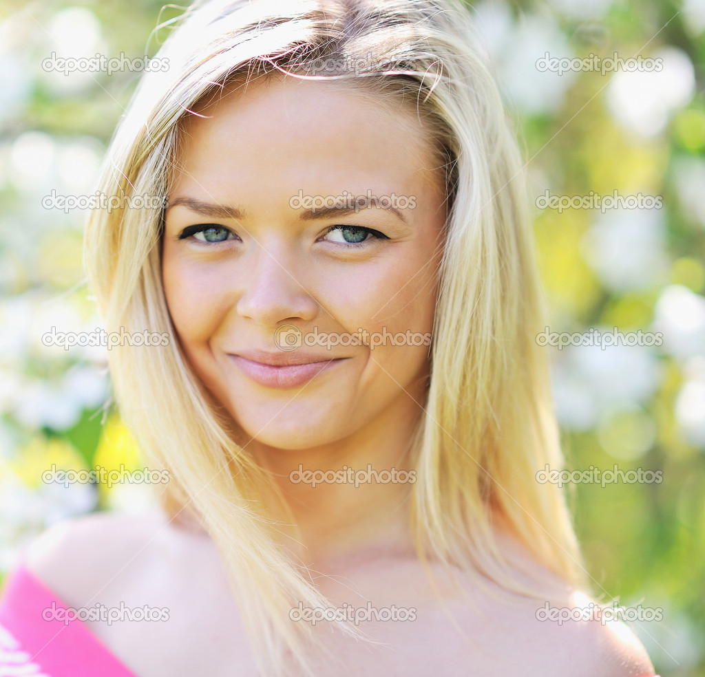 Portrait of a beautiful young woman looking at you and smiling