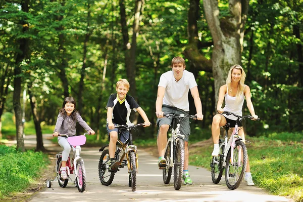 Familjen i parken på cyklar — Stockfoto