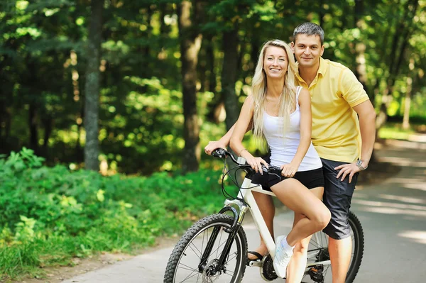 Couple on a bike in a countryside — Stock Photo, Image