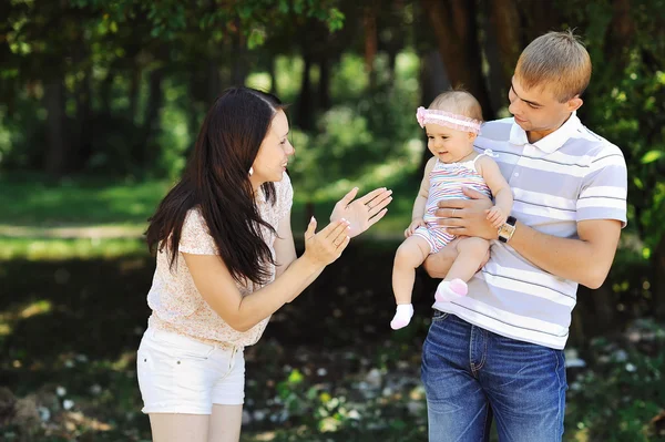 Happy family in a park — Stock Photo, Image