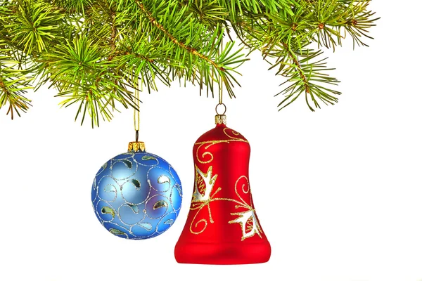 Christmas decoration-glass red bell and blue ball on fir branch — Stock Photo, Image