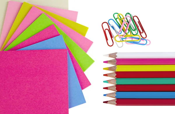 Colorful pencils, clips and note papers on white background — Stock Photo, Image