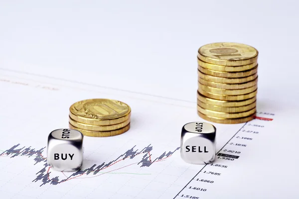 Financial settlement with the charts, coins rouleau and dices cu — Stock Photo, Image