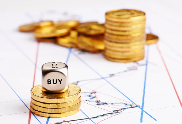 Stacks of coins, dices cube with word BUY and a up trend chart — Stock Photo, Image