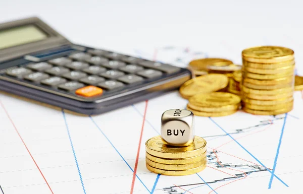 Dices cube with word BUY, coins, calculator on the financial ch — Stock Photo, Image