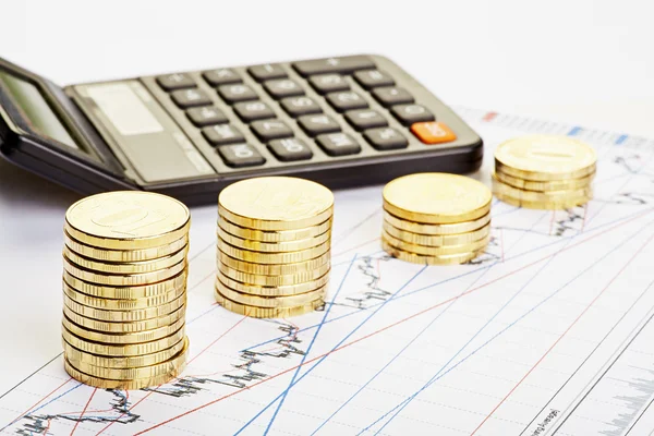 Downtrend stacks of coins, a calculator on the financial chart. — Stock Photo, Image