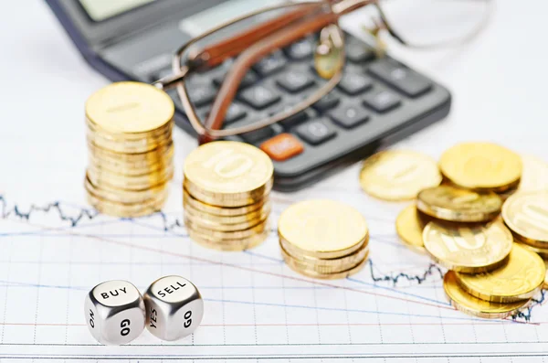 Downtrend stacks coins, calculator, glasses and dices cubes with — Stock Photo, Image