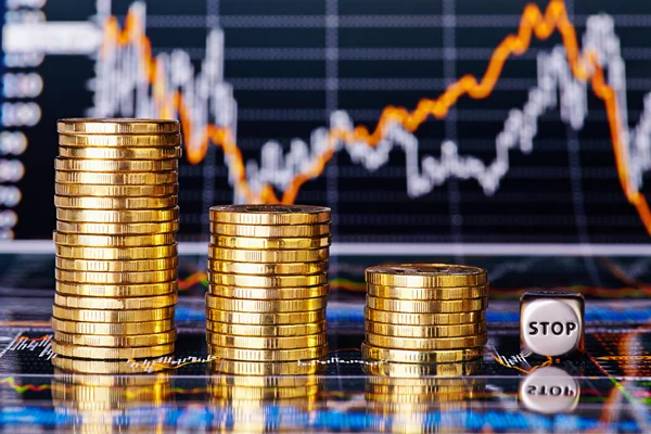 Downtrend financial chart, stacks of golden coins and dices cube — Stock Photo, Image