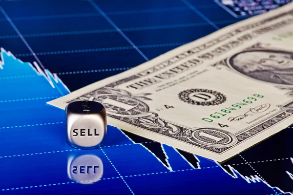 Dices cube with the word SELL, one-dollar banknote and downtrend — Stock Photo, Image