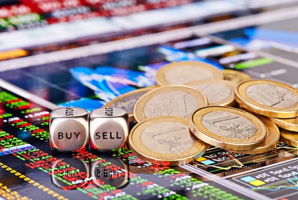 Dices cubes with the words SELL BUY, one-euro coins and a financ — Stock Photo, Image