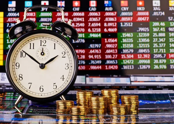 Stacks of golden coins, clock and the financial chart as backgro — Stock Photo, Image