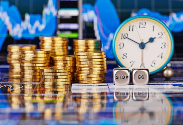 Stacks of golden coins, clock, dices cubes with the words STOP G — Stock Photo, Image