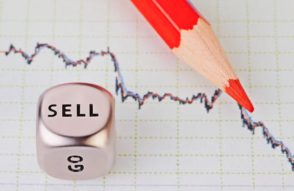 Downtrend chart, red pencil and dice cube with the word SELL. Сэл — стоковое фото