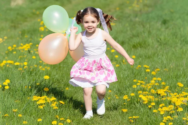 Child playing with balloons — Stock Photo, Image