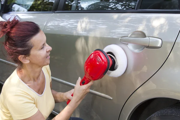 Mediados de edad linda mujer pulido coche —  Fotos de Stock