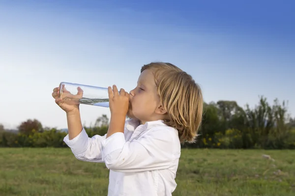 Giovane ragazzo acqua potabile all'aperto — Foto Stock