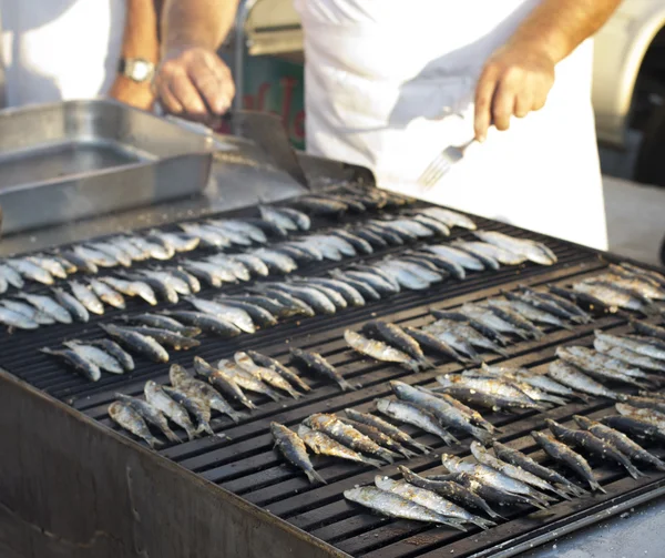 Chef grilling young sardines — Stock Photo, Image