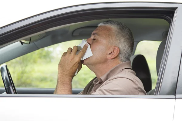 Sneezing man in the car — Stock Photo, Image