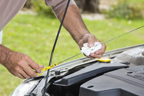 Checking level of oil in the car Royalty Free Stock Images