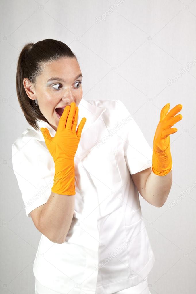 Surprised female doctor wearing latex gloves
