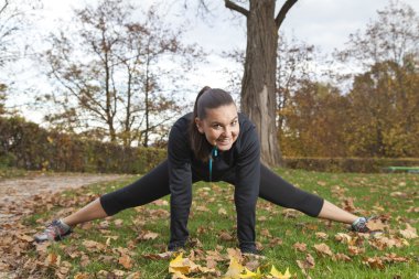 güzel bir genç kadın parkta germe