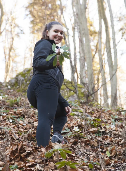 Cute young woman picking a hellebore — Stock Photo, Image