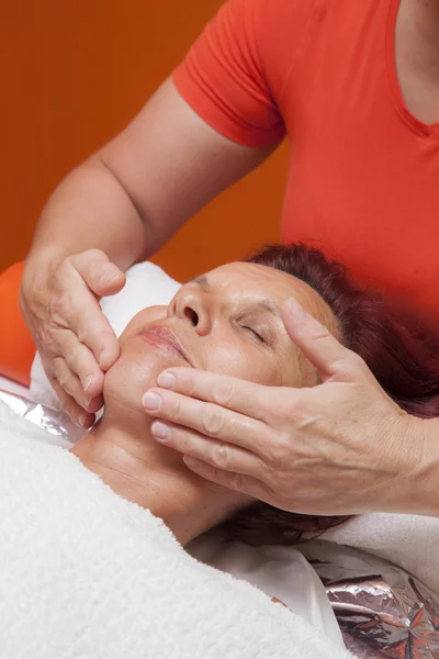 Cute woman gets professional facial massage, lymphatic drainage — Stock Photo, Image