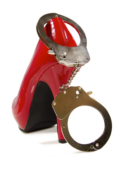 Handcuffs and high heel — Stock Photo, Image