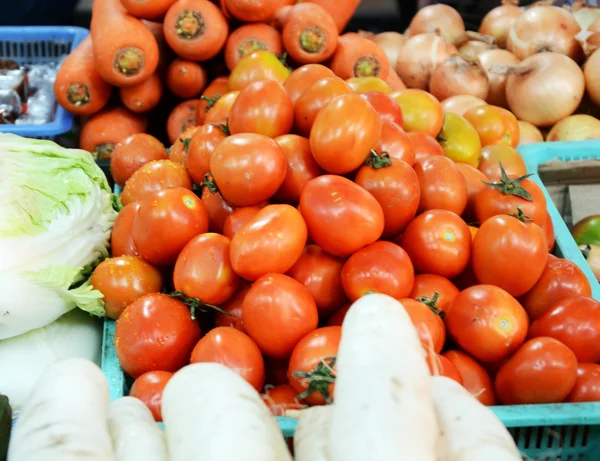 Baskets of tomatoes and vegetable — Stock Photo, Image