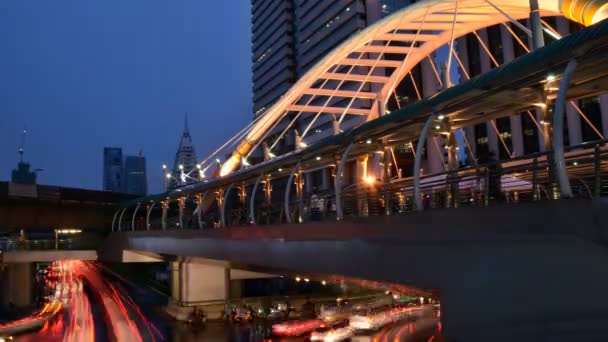 Buildings and public sky walk for transit between Sky Transit and Bus Rapid Transit Systems at Sathorn-Narathiwas junction, bangkok, thailand — Stock Video