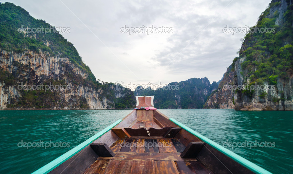 Beautiful high mountains and green river on long tail boat at Ra