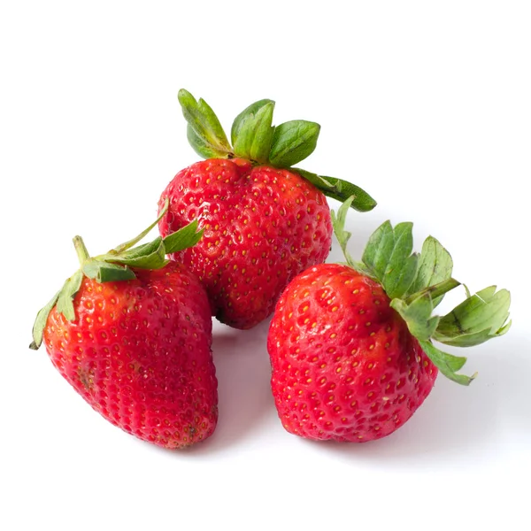 Three strawberries with leaves on a white — Stock Photo, Image