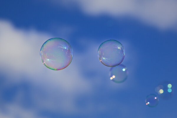 Bubbles over a cloudy blue sky