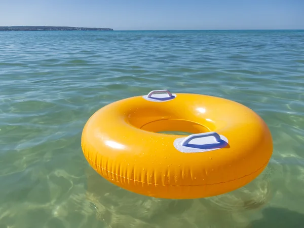 Orange rubber ring in the sea — Stock Photo, Image