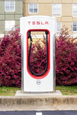 Tesla supercharger station in a parking area.