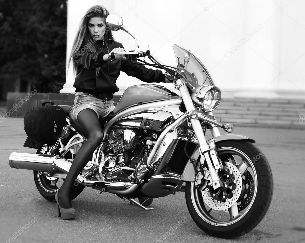Shot of young woman on a motorbike looking sexy