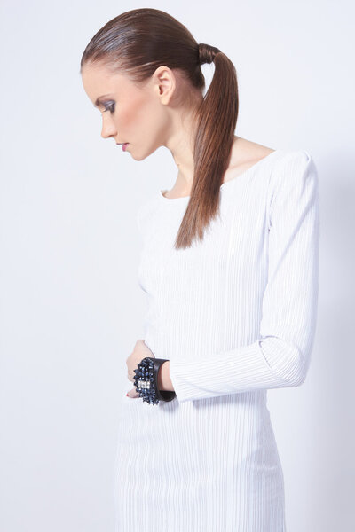 Profile shot of beautiful female model in white dress with amazi