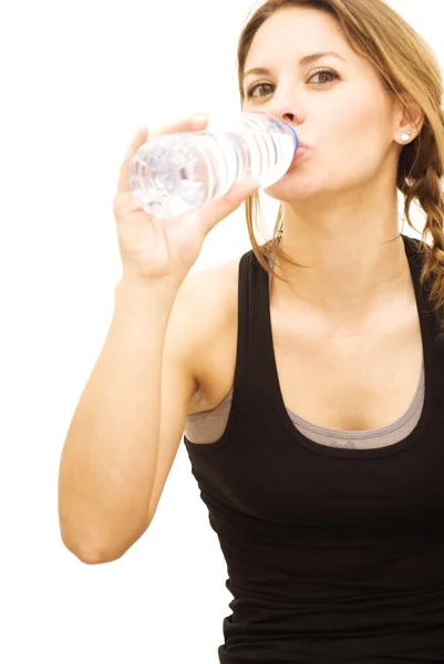 Beautiful woman drinking water after playing sports — Stock Photo, Image