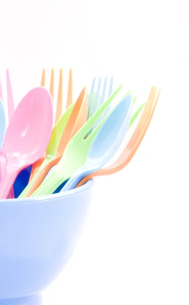 Plastic tableware consisting of spoon, fork and bowls — Stock Photo, Image