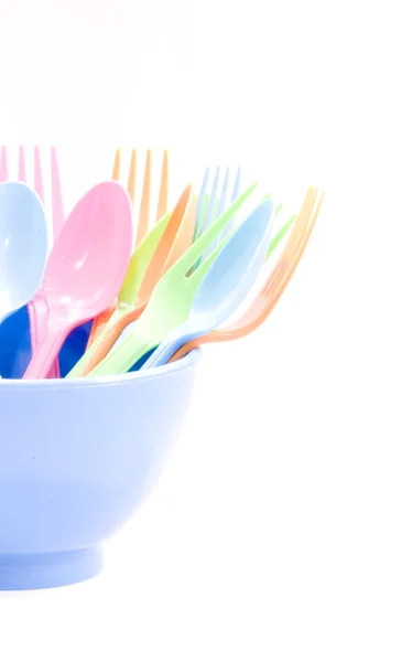 Plastic tableware consisting of spoon, fork and bowls — Stock Photo, Image