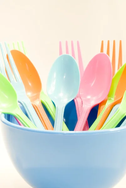 Plastic tableware consisting of spoon, fork and bowls — Stock Photo, Image