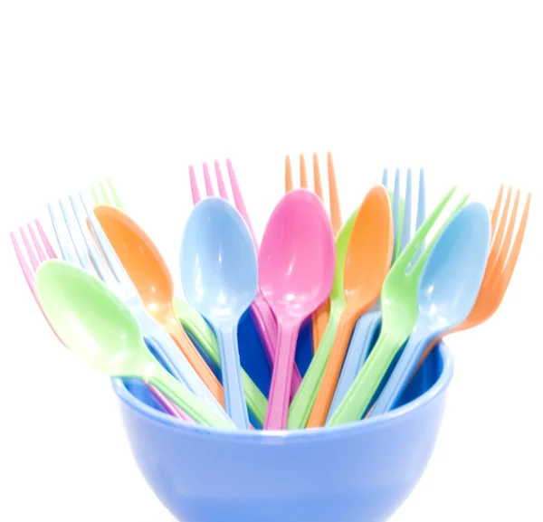 Plastic tableware consisting of spoon, fork and bowls — Stock Photo, Image