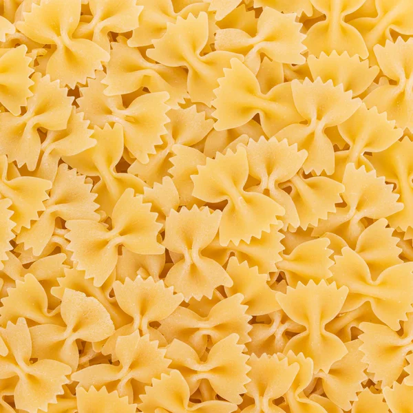 इतालवी Farfalle पास्ता कच्चे खाद्य पृष्ठभूमि या बनावट — स्टॉक फ़ोटो, इमेज