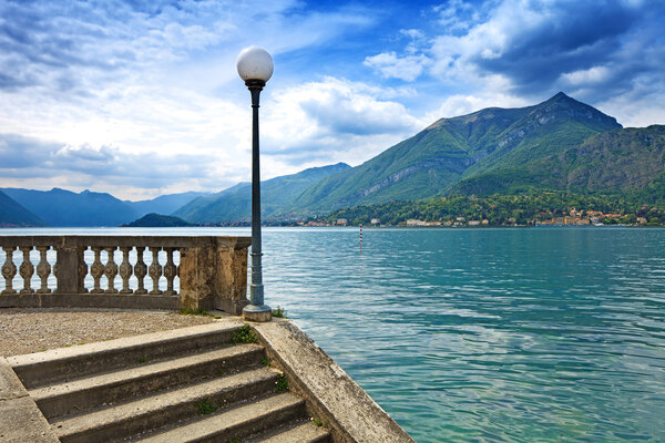 Como Lake landscape. Street Lamp post, stairs, mountains and water. Bellagio Italy