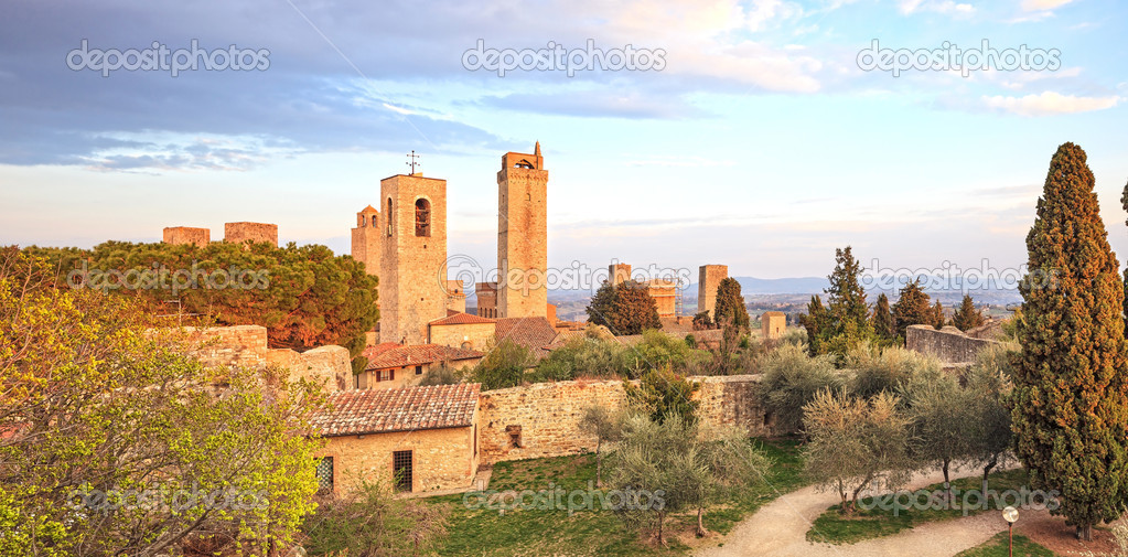 San Gimignano landmark medieval town on sunset, towers and park.