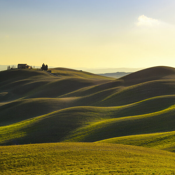 Tuscany, sunset rural landscape. Rolling hills, countryside farm, trees.
