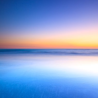 White beach and blue ocean on twilight sunset clipart